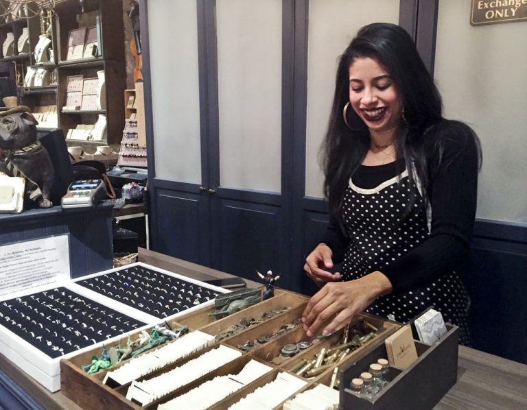 Aylin Rodriguez at Stone Flower, a clothing and jewelry store in Williamsburg, where she waits on customers, runs the cash register, stocks inventory -- often all by herself.